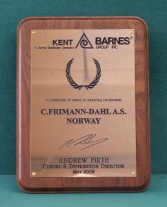 Bronze plaque mounted on wood